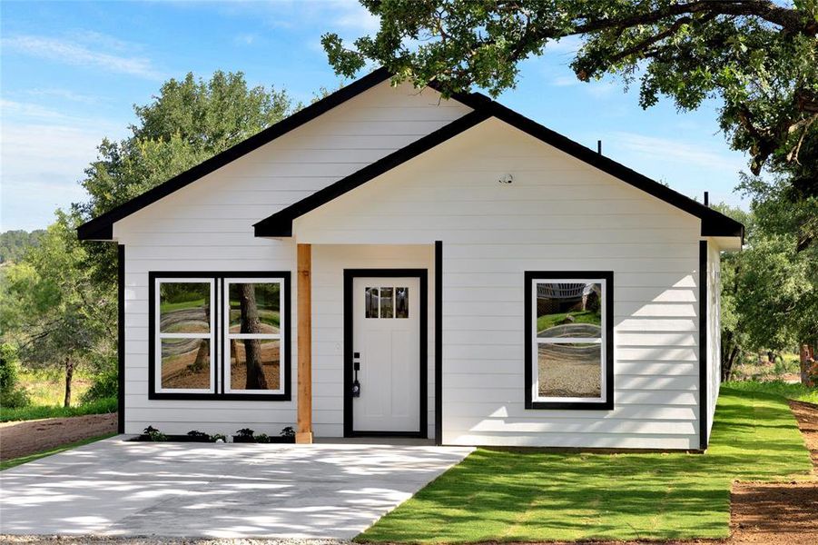 Front exterior of a new home in , Mineral Wells, TX, highlighting curb appeal (Image 25).