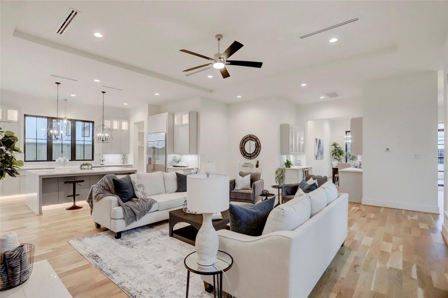 The first-floor living area offers open views to the island kitchen and formal dining, as well as overlooks the turf yard and lanai.