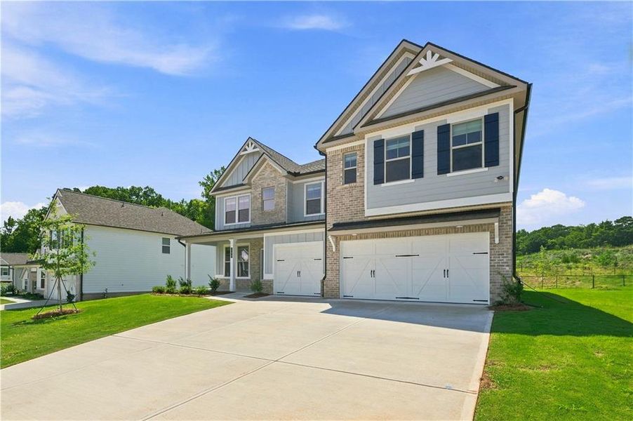 Front exterior of a new home in Grandview at Millers Mill, Stockbridge, GA, highlighting curb appeal (Image 16).