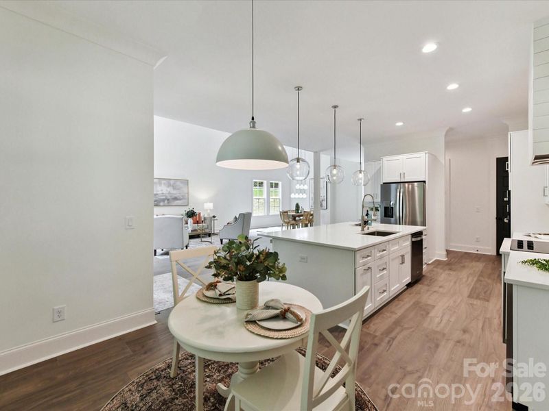 Cozy breakfast nook overlooking the open-concept kitchen and living area, perfect for casual dining and morning coffee.