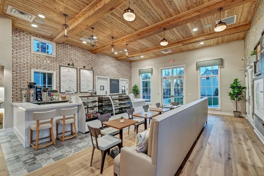 Living room with brick wall, healthy amount of natural light, light wood finished floors, a wood ceiling with exposed beams, and recessed lighting Living room with brick wall, healthy amount of natural light, light wood finished floors, a wood ceiling with exposed beams, and recessed lighting