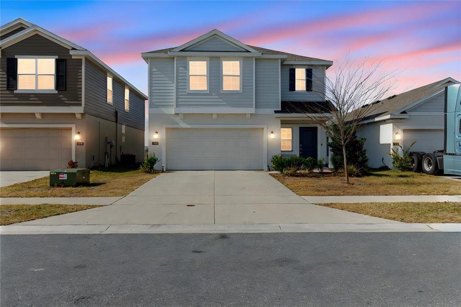 Front exterior of a new home in Peace Creek Reserve, Winter Haven, FL, highlighting curb appeal (Image 21). Front exterior of a new home in Peace Creek Reserve, Winter Haven, FL, highlighting curb appeal (Image 21).