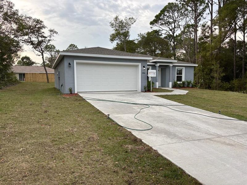 Front exterior of a new home in , Citrus Springs, FL, highlighting curb appeal (Image 1).