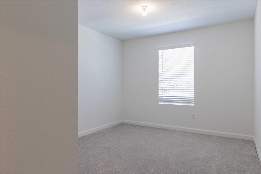 Bedroom 2 is well lit by the window size and can fit a queen-sized bed