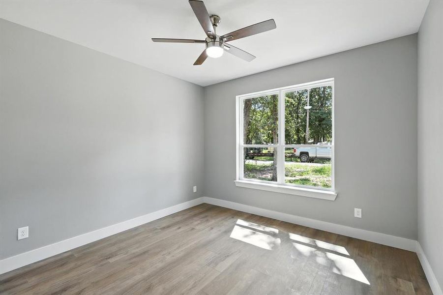 Spare room with wood finished floors and ceiling fan