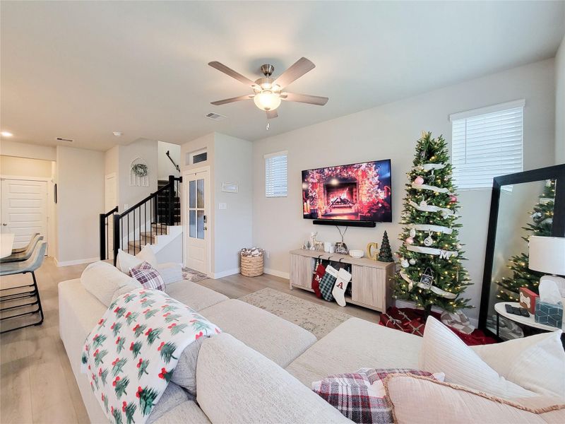 This cozy living room leads to a staircase to the upper floor, enhancing the home's spacious feel.