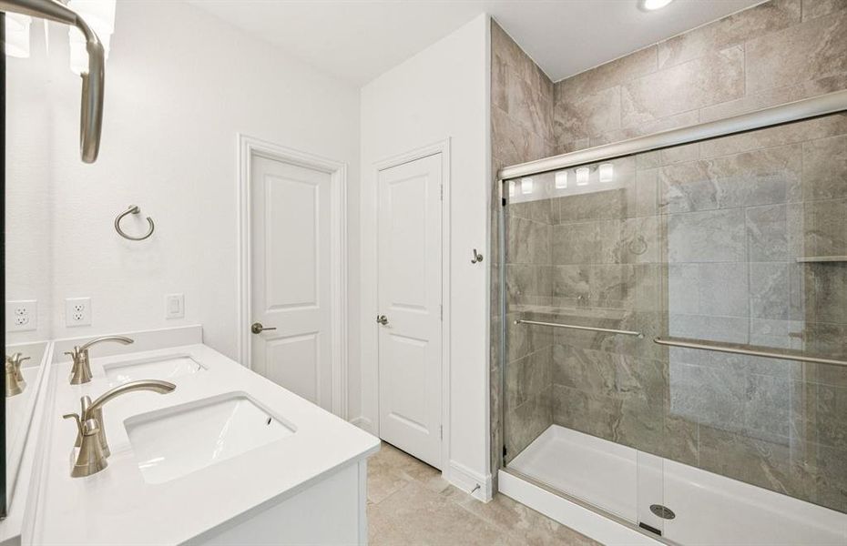 Owner's bath with double vanity and spacious shower *Real home pictured