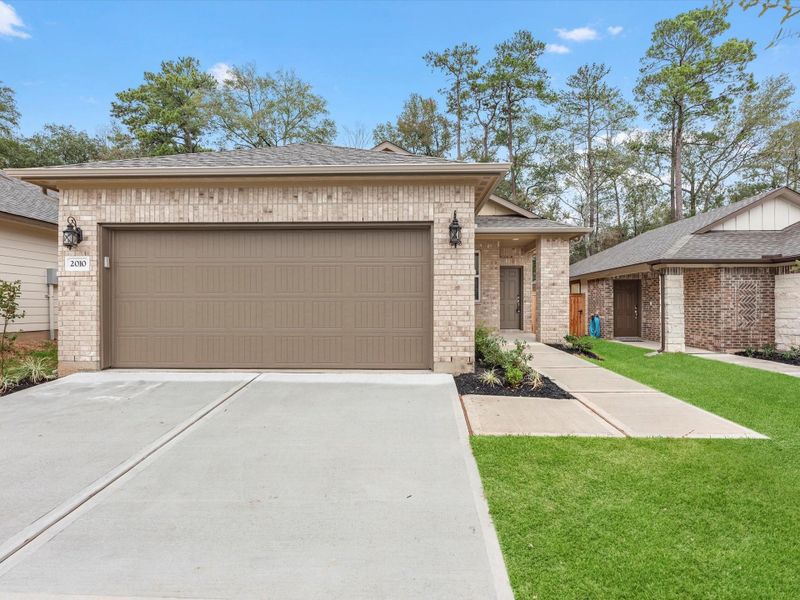 Front exterior of a new home in Montgomery Oaks - Premier, Conroe, TX, highlighting curb appeal (Image 20).