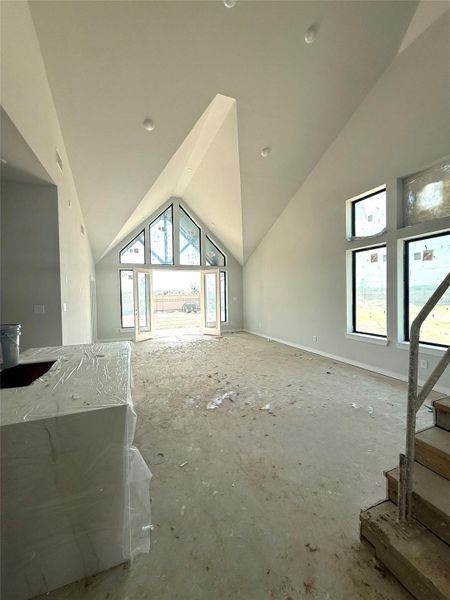 The best-selling Maverick plan by Newmark Homes features soaring high ceilings in the family room overlooking a huge covered patio. The best-selling Maverick plan by Newmark Homes features soaring high ceilings in the family room overlooking a huge covered patio.