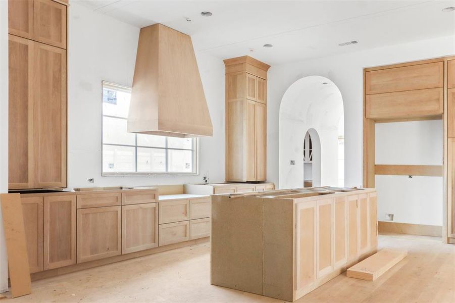 Kitchen with a kitchen island and light brown cabinets