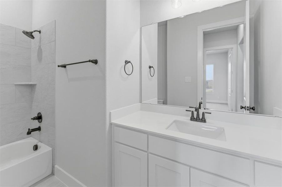 Bathroom featuring shower / washtub combination and vanity