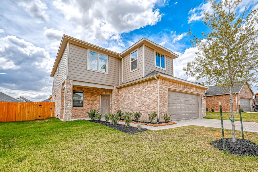 Representative exterior photo of a completed home built from the Floor Plan 2340 by Colina Homes in Grand Magnolia, Magnolia, TX (Image 2). Representative exterior photo of a completed home built from the Floor Plan 2340 by Colina Homes in Grand Magnolia, Magnolia, TX (Image 2).