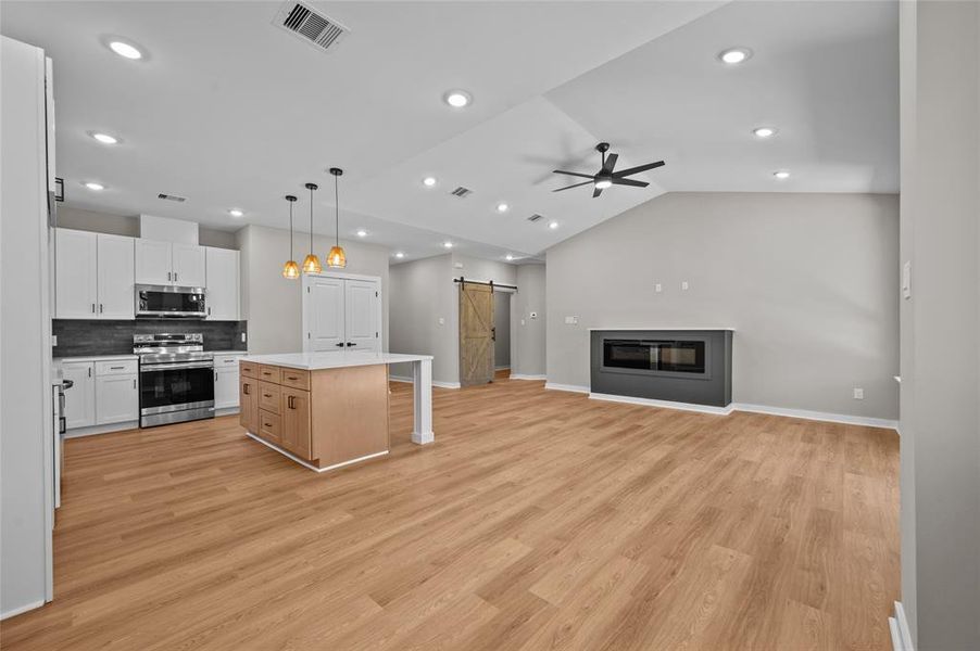 Plenty of space looking from the breakfast room, large electric fireplace and high ceilings.