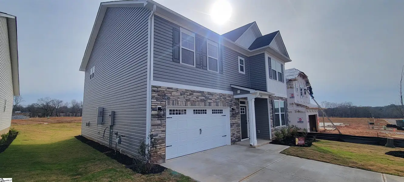 Front exterior of a new home in Halton Oaks, Spartanburg, SC, highlighting curb appeal (Image 2).