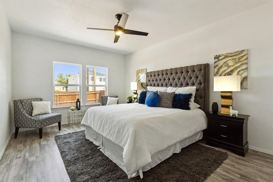 Bedroom featuring ceiling fan and light hardwood / wood-style flooring