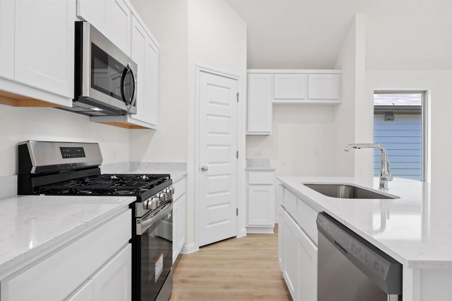 Kitchen in the Cypress home plan by Trophy Signature Homes - REPRESENTATIVE PHOTO
