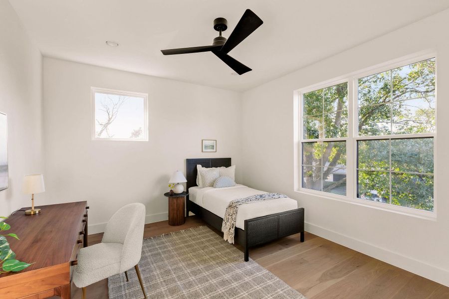 Bedroom with light wood-type flooring and ceiling fan Bedroom with light wood-type flooring and ceiling fan