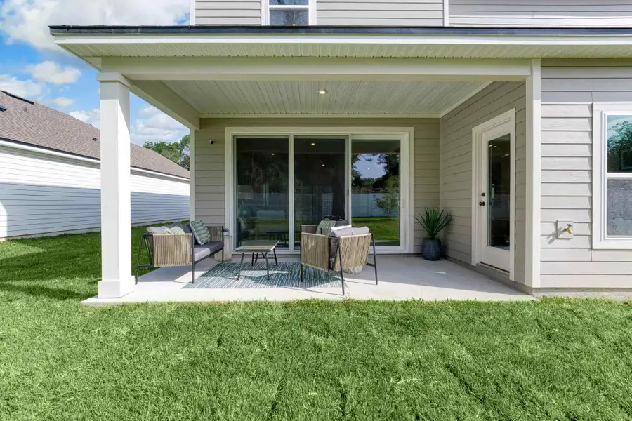 A house with a patio and a table and chairs.