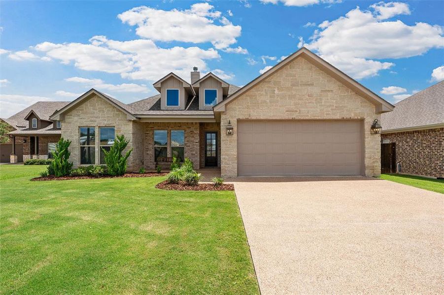 Stone and brick front elevation with attached two-car garage. Stone and brick front elevation with attached two-car garage.