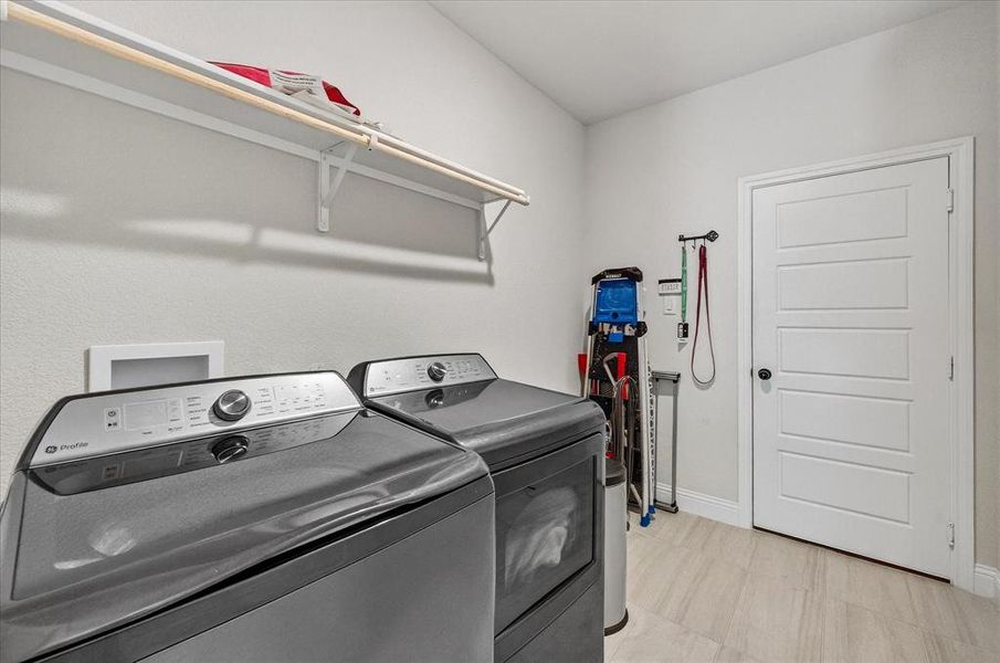 Laundry room with baseboards and washing machine and dryer Laundry room with baseboards and washing machine and dryer
