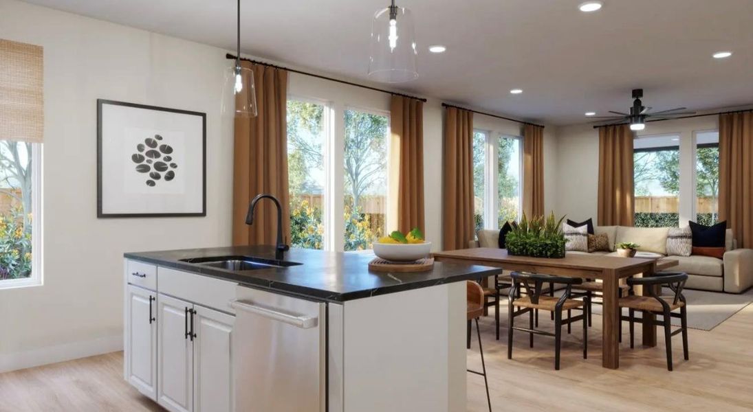 Kitchen with open floor plan, an island with sink, light wood-type flooring, hanging light fixtures, and white cabinetry