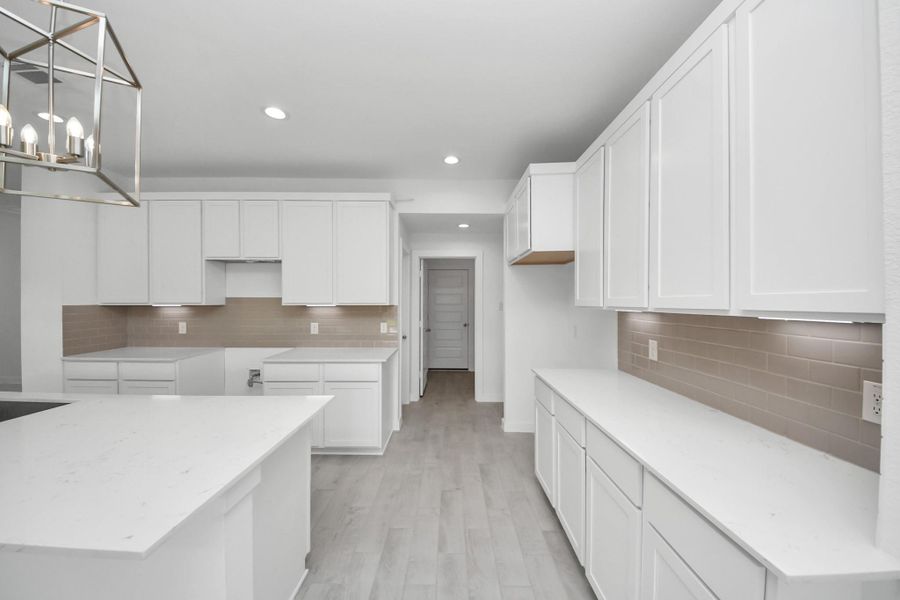 The open concept effortlessly connects the kitchen to the expansive family room, forming a perfect hub for gatherings. This seamless flow creates an inviting space where cooking and socializing come together harmoniously. Sample photo of completed home with similar floor plan. Actual colors and selections may vary. The open concept effortlessly connects the kitchen to the expansive family room, forming a perfect hub for gatherings. This seamless flow creates an inviting space where cooking and socializing come together harmoniously. Sample photo of completed home with similar floor plan. Actual colors and selections may vary.