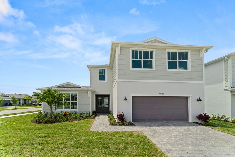 Front exterior of a new home in Tradition - Kenley, Port St. Lucie, FL, highlighting curb appeal (Image 1).