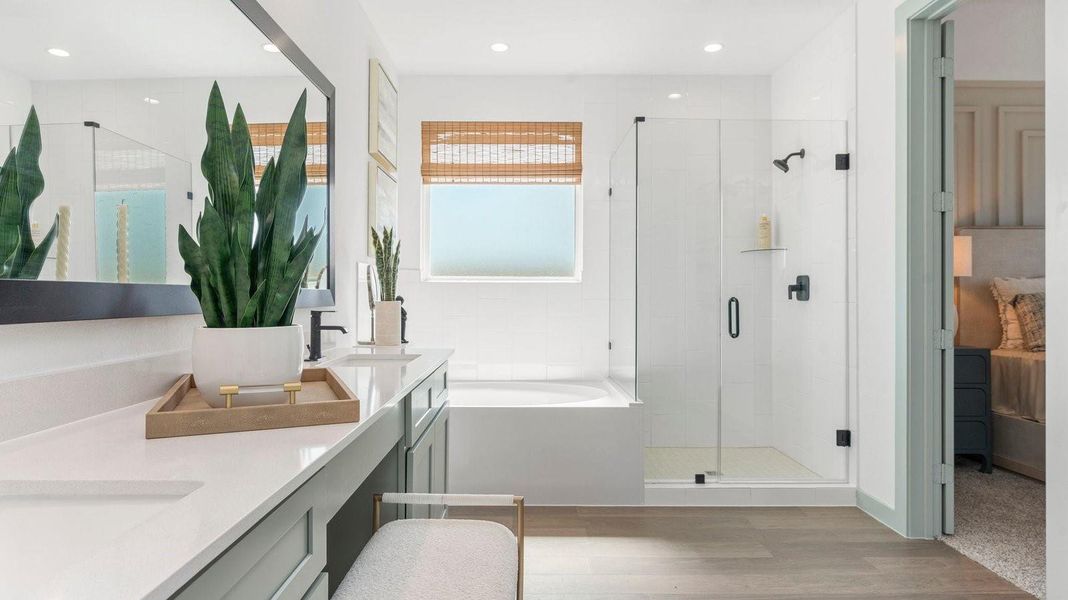 Primary bathroom with a glass-enclosed standing shower and separate soaking tub. Primary bathroom with a glass-enclosed standing shower and separate soaking tub.