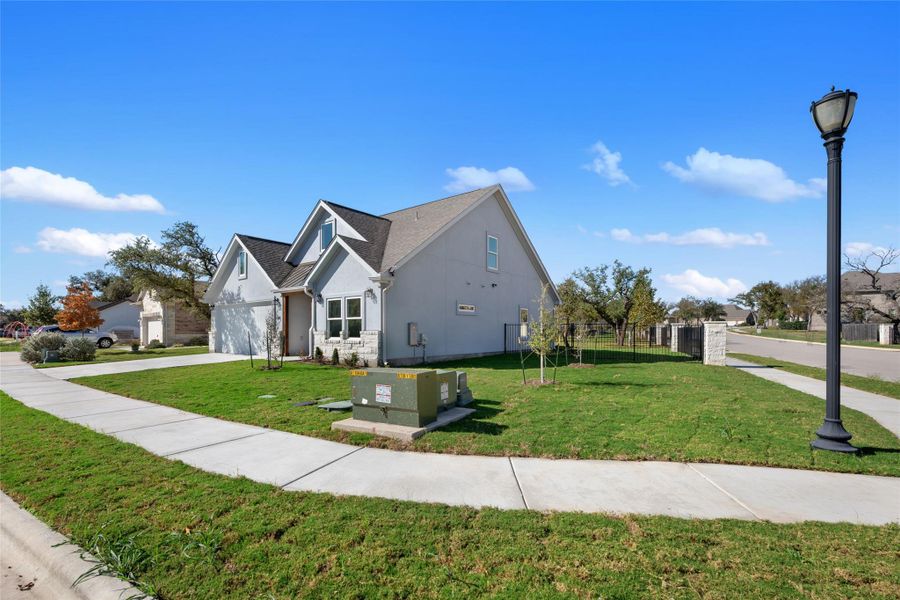 View of home's exterior with concrete driveway, a garage, and stucco siding