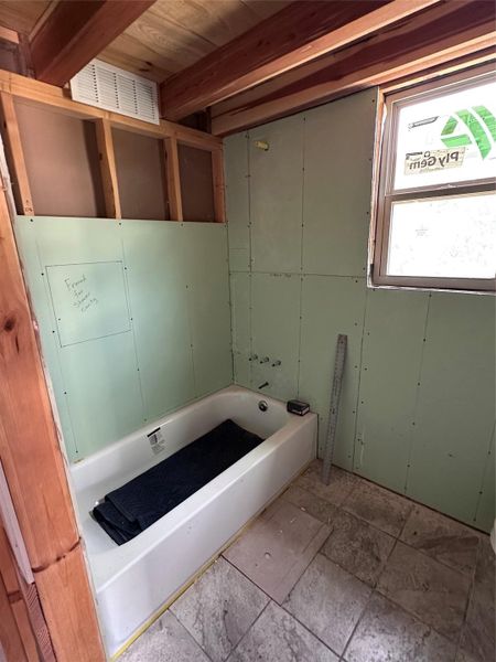 A partially finished bathroom offers a tub ready for customization.