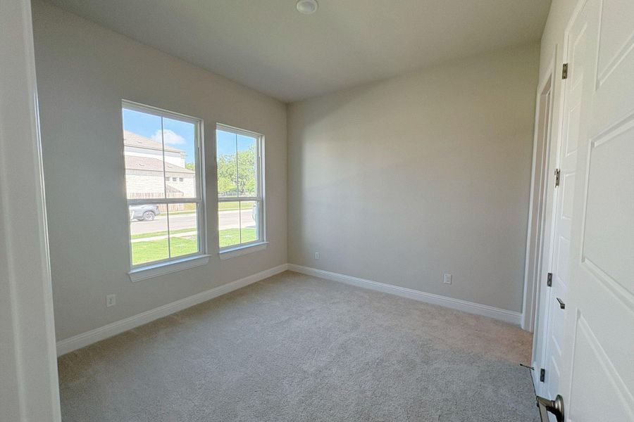 Room featuring two large windows, neutral wall tones, and light-colored carpeting