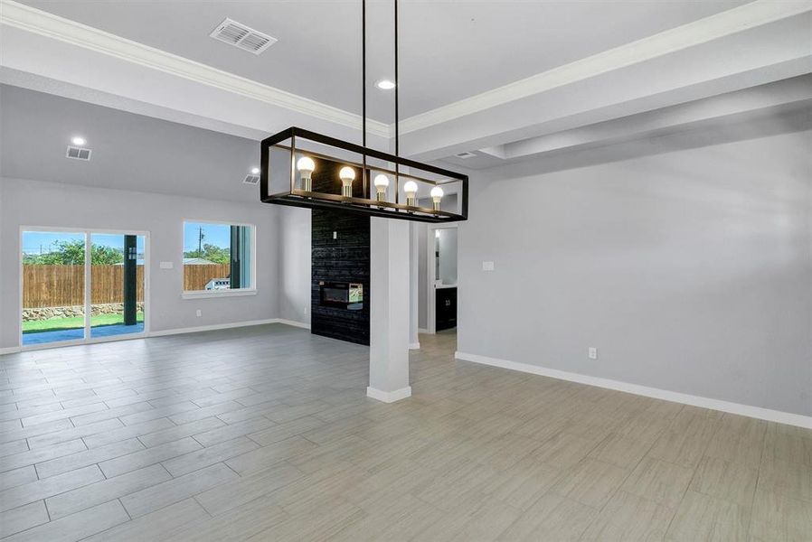 Unfurnished dining area with a fireplace, light hardwood / wood-style floors, and ornamental molding