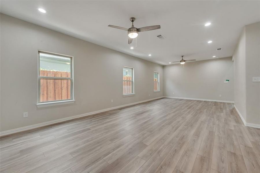 Empty room with light hardwood / wood-style flooring and ceiling fan