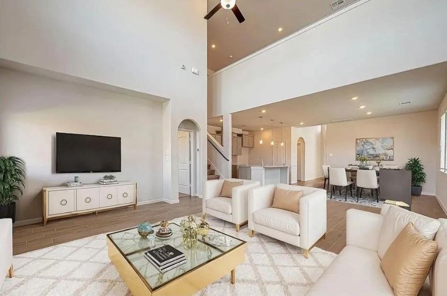 Soaring high ceilings create an open, airy feel and make this living space feel even more impressive.Virtually staged