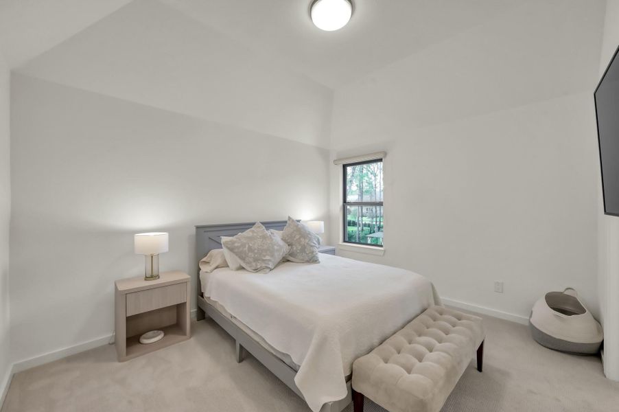 Each secondary bedroom offers generous space and its own private en-suite bath. This is the first of three upstairs bedrooms.