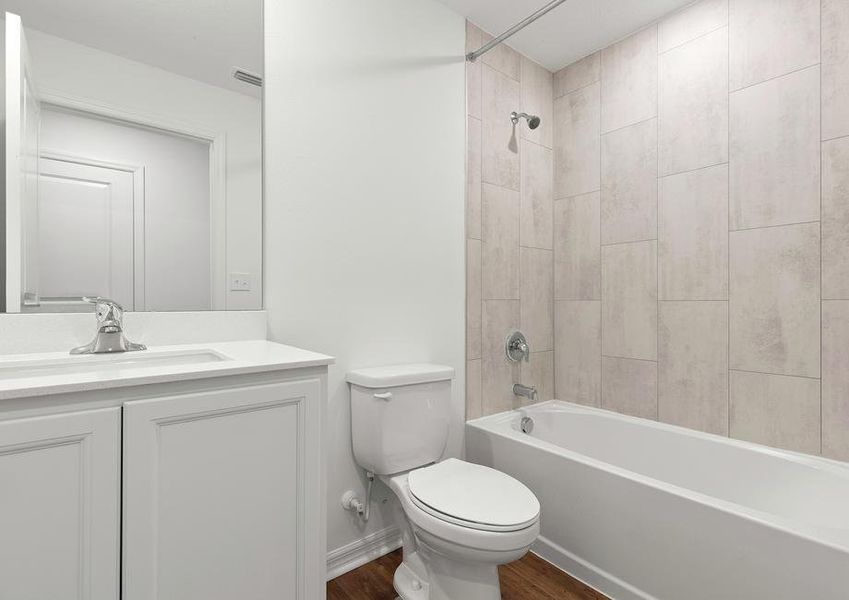 The guest bathroom has a beautifully tiled bathtub