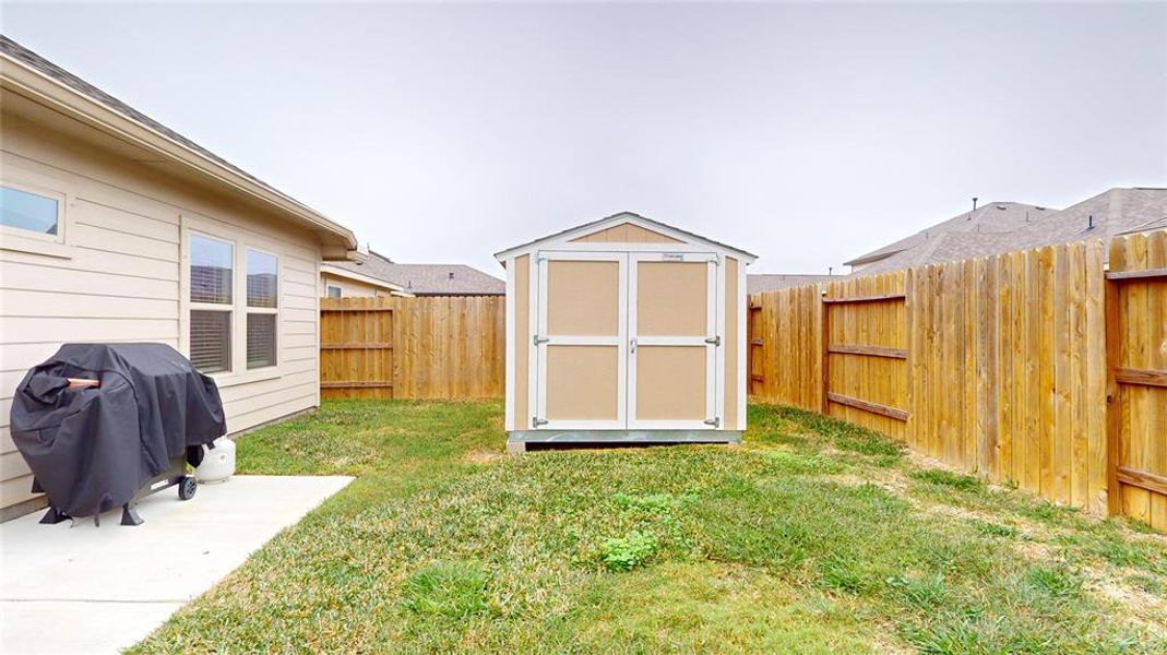 There's a storage shed and fenced yard, offering a private outdoor space ideal for relaxation and storage for your yard equipment.