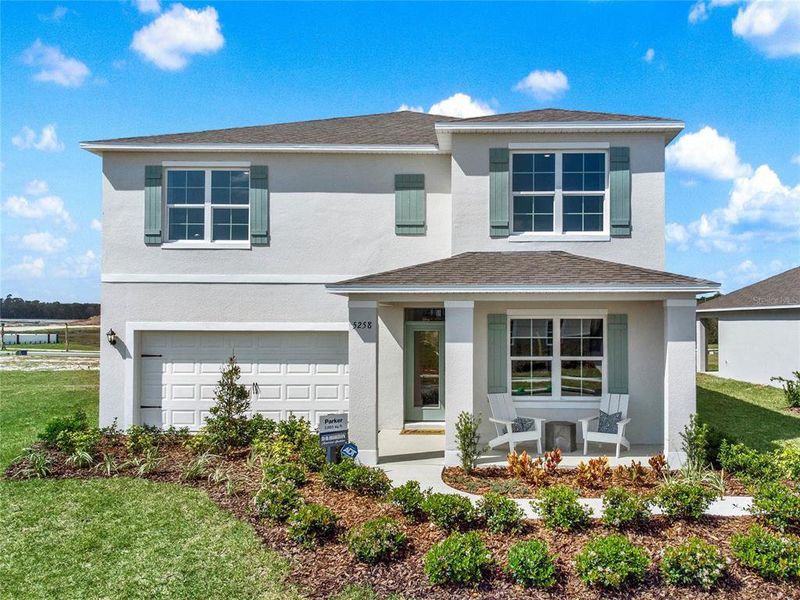 Front exterior of a new home in Windrose, Apopka, FL, highlighting curb appeal (Image 1).