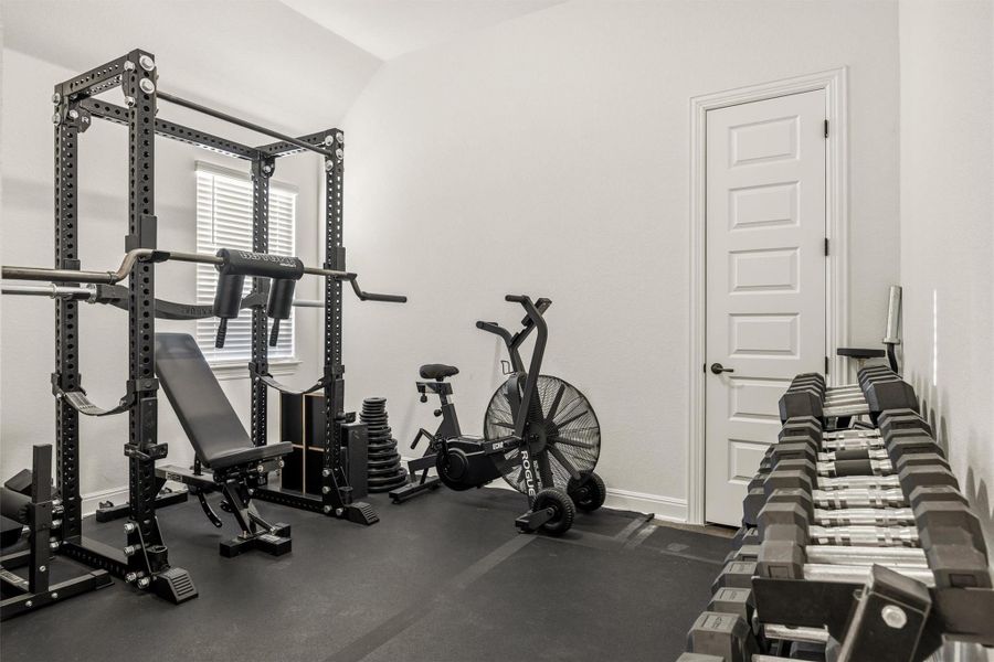 Exercise room featuring lofted ceiling