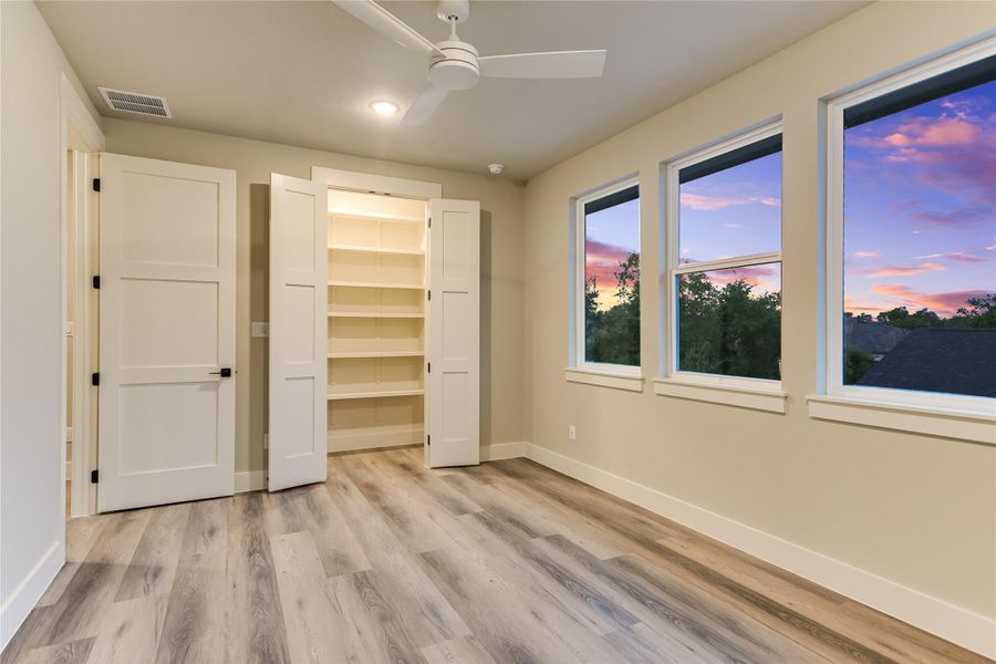 Bedroom 3 featuring light wood-style floors and a ceiling fan Bedroom 3 featuring light wood-style floors and a ceiling fan