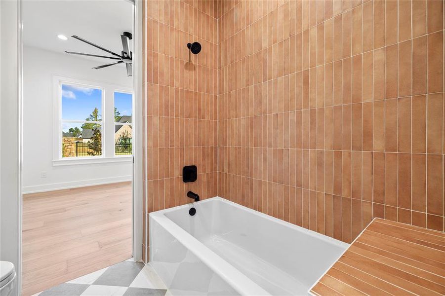 Bathroom featuring washtub / shower combination and recessed lighting