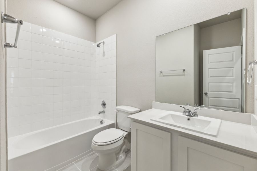 Bathroom in the Pecan home plan by Trophy Signature Homes – REPRESENTATIVE PHOTO