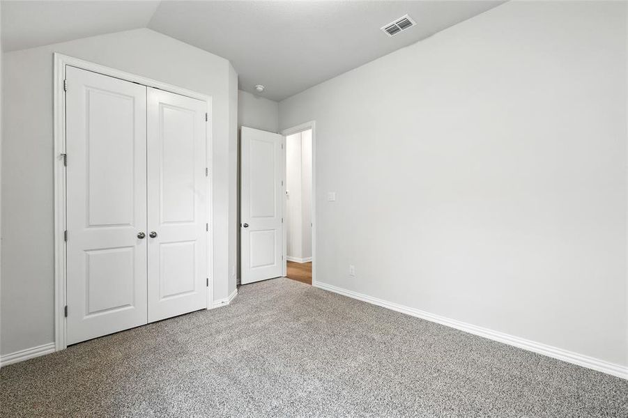 Unfurnished bedroom with carpet and a closet