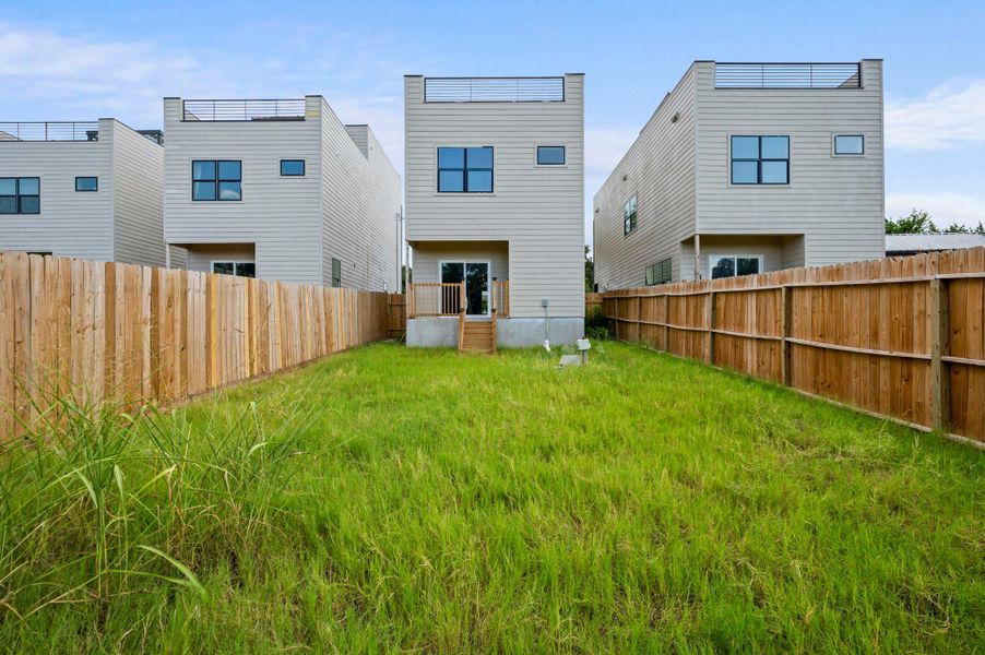 Rear view of property featuring a fenced backyard