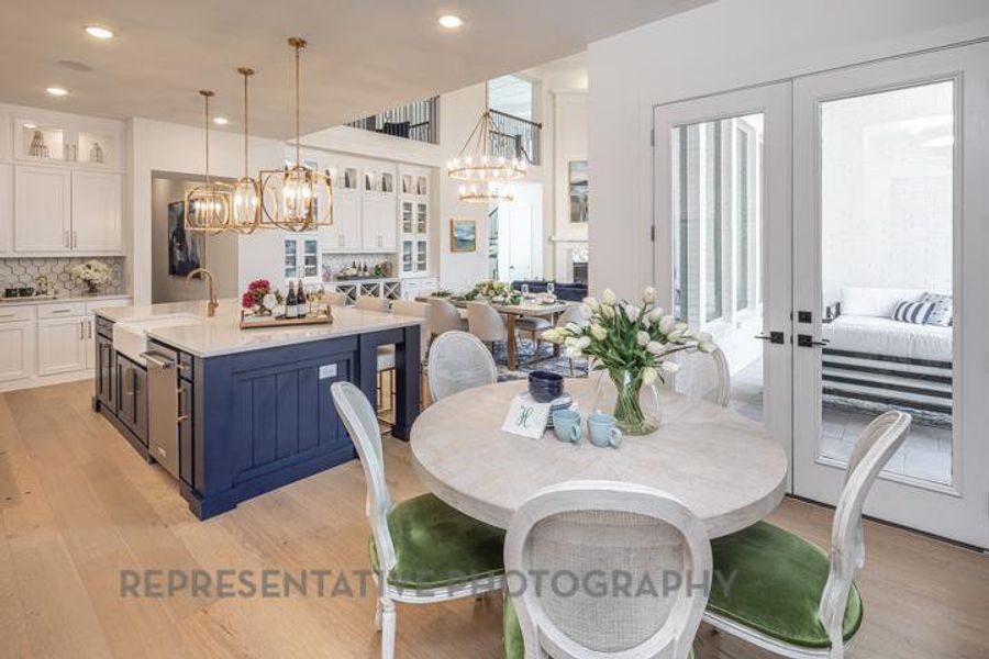 Dining space featuring a notable chandelier, light wood finished floors, french doors, and recessed lighting Dining space featuring a notable chandelier, light wood finished floors, french doors, and recessed lighting