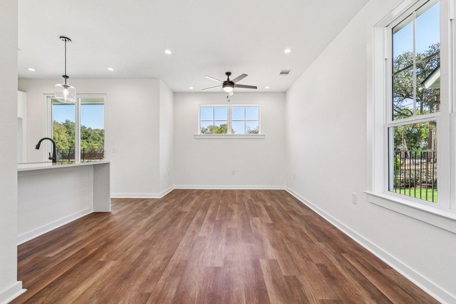 Unfurnished living room with recessed lighting, dark wood-style flooring, and a ceiling fan Unfurnished living room with recessed lighting, dark wood-style flooring, and a ceiling fan