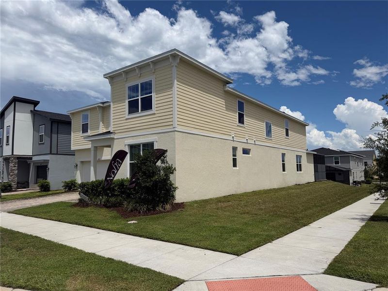 Front exterior of a new home in Solara Resort, Kissimmee, FL, highlighting curb appeal (Image 16).