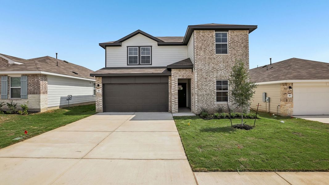 Front exterior of a new home in Prairie Lakes, Buda, TX, highlighting curb appeal (Image 2).