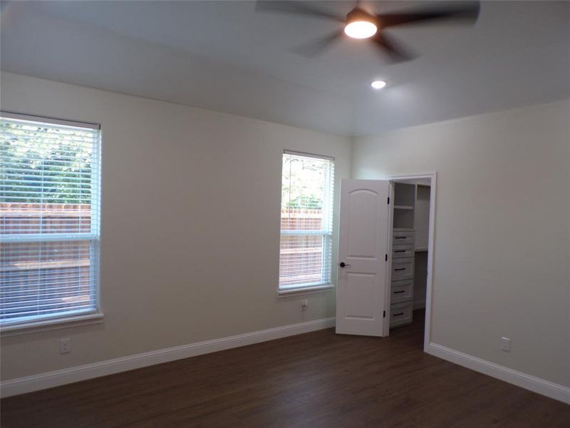 master bedroom featuring ceiling fan and dark hardwood / wood-style flooring