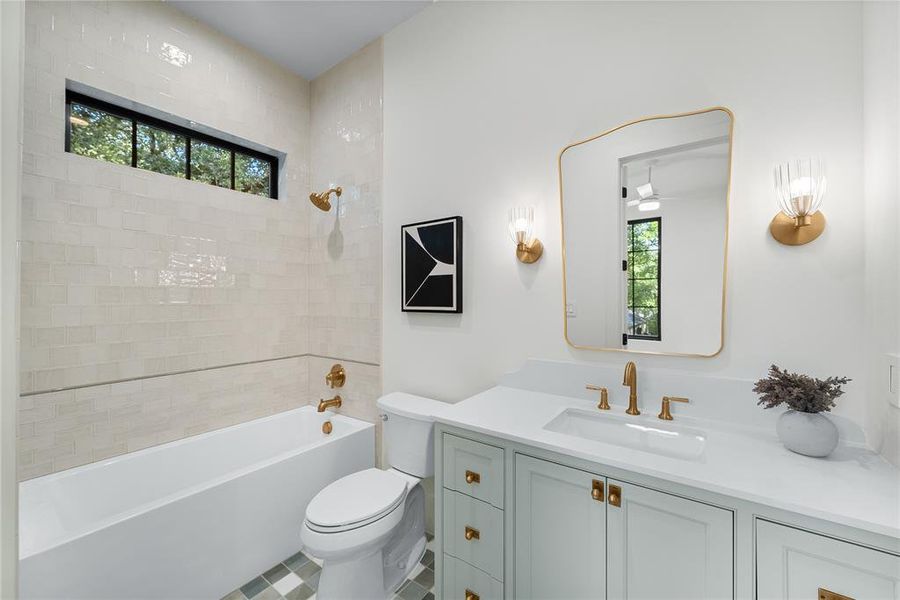 Bathroom featuring a white built-in tub, light-toned rectangular tile surround, and a clerestory window